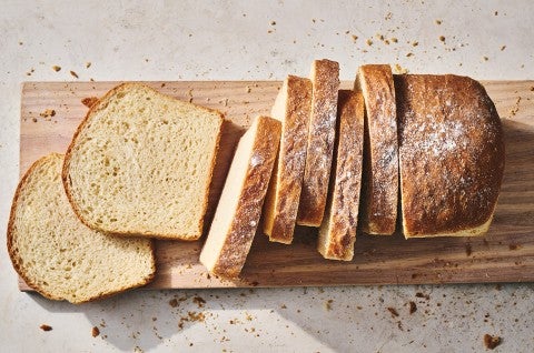 Sliced sandwich bread on a cutting board. - select to zoom