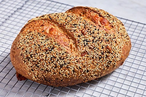 Parmesan Black Pepper Sourdough Bread fresh out of the oven and cooling on a wire rack.