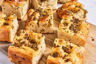Side view of stuffing focaccia showing the integrated ingredients and rise of the bake.